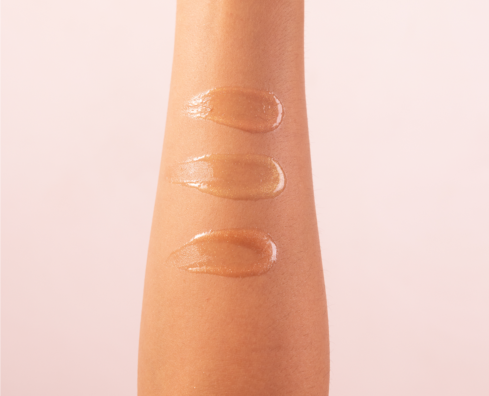 close up of body oil streaked on inside of forearm